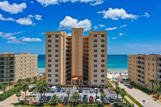 view of property with a beach view and a water view