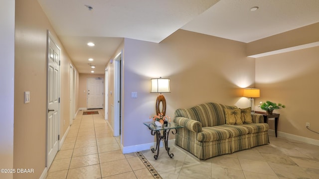 interior space with light tile patterned flooring, baseboards, and recessed lighting