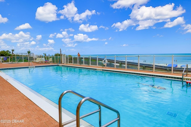 pool featuring a water view and fence