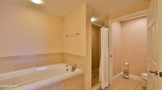 full bathroom featuring a tile shower, toilet, a garden tub, a textured ceiling, and tile patterned flooring