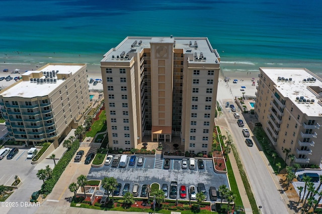 drone / aerial view featuring a beach view and a water view