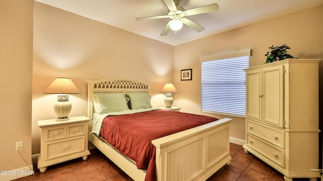 bedroom with baseboards, ceiling fan, and dark tile patterned floors