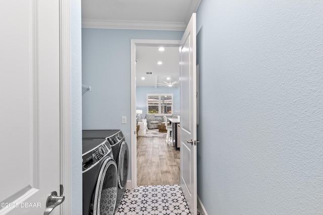 laundry room with hardwood / wood-style flooring, ornamental molding, and independent washer and dryer