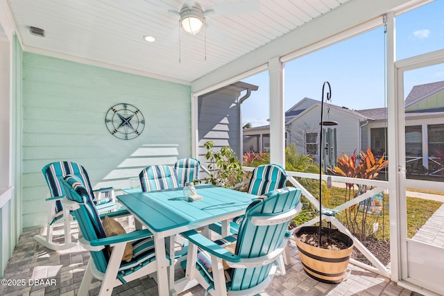 sunroom / solarium featuring ceiling fan