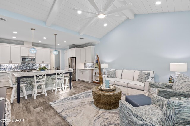 living room featuring hardwood / wood-style flooring and lofted ceiling with beams