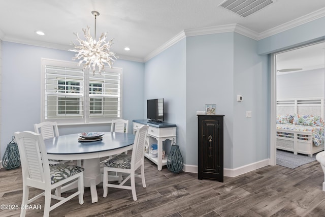 dining area with ornamental molding, wood-type flooring, and a notable chandelier