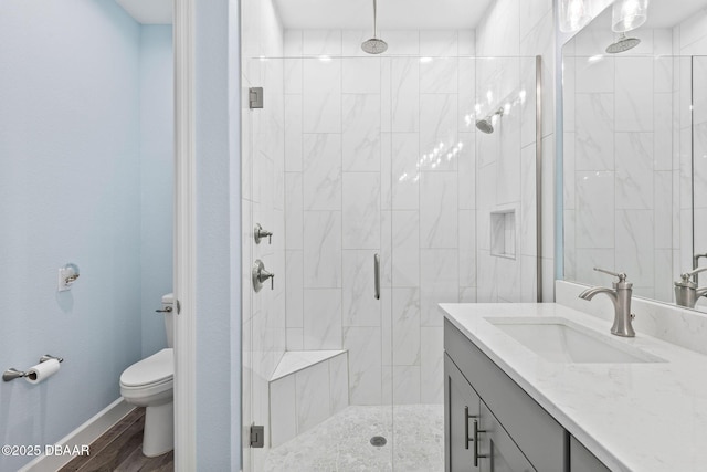 bathroom featuring an enclosed shower, vanity, hardwood / wood-style flooring, and toilet