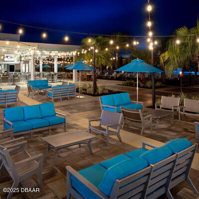 patio at night featuring an outdoor living space