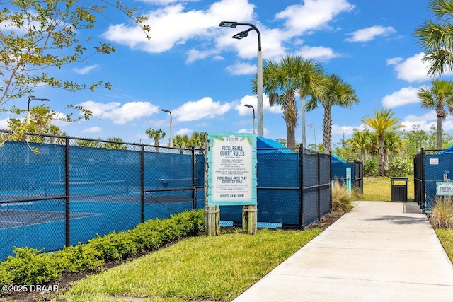 view of community featuring tennis court