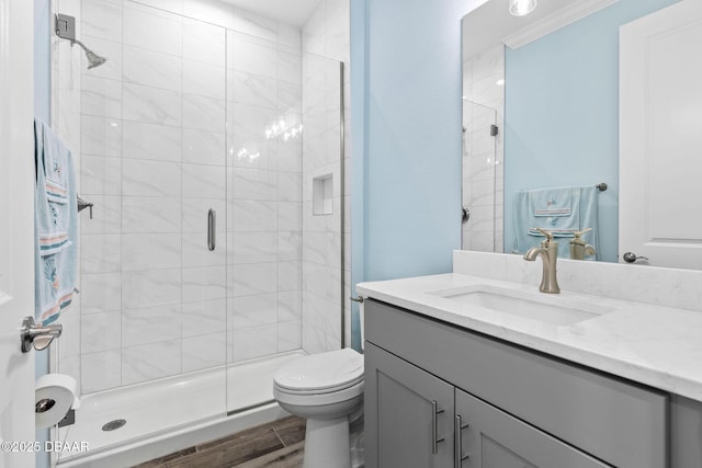 bathroom with vanity, wood-type flooring, a shower with door, and toilet