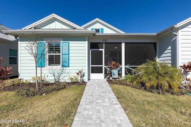 doorway to property featuring a yard