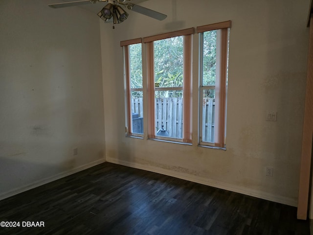 spare room featuring ceiling fan and dark wood-type flooring