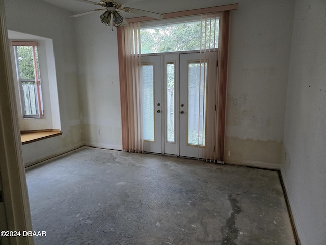 foyer with french doors, ceiling fan, and a healthy amount of sunlight