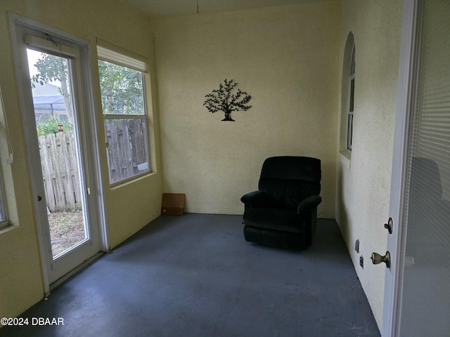 living area with plenty of natural light and concrete floors