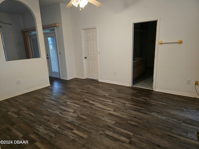 empty room featuring ceiling fan and dark wood-type flooring