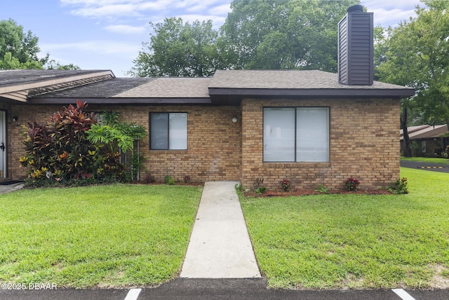 1518 Franklin Cir, Holly Hill, FL 32117 - ranch-style house featuring a front lawn, brick siding, a chimney, and a shingled roof