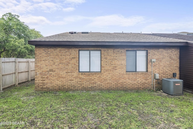 1518 Franklin Cir, Holly Hill, FL 32117 - view of side of home with a shingled roof, brick siding, and central AC unit