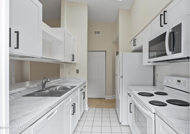 1518 Franklin Cir, Holly Hill, FL 32117 - kitchen featuring white appliances, open shelves, a sink, light tile patterned flooring, and white cabinets