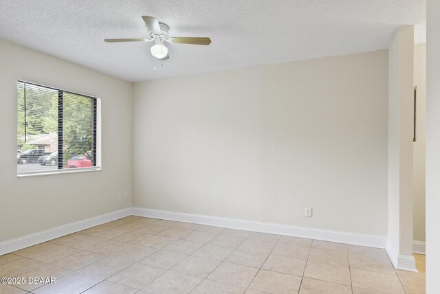 1518 Franklin Cir, Holly Hill, FL 32117 - unfurnished room with a textured ceiling, ceiling fan, baseboards, and light tile patterned floors