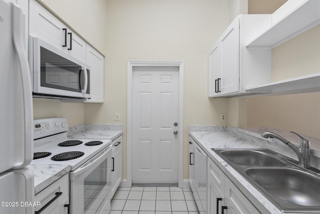 1518 Franklin Cir, Holly Hill, FL 32117 - kitchen featuring white appliances, a sink, light tile patterned flooring, white cabinets, and light countertops