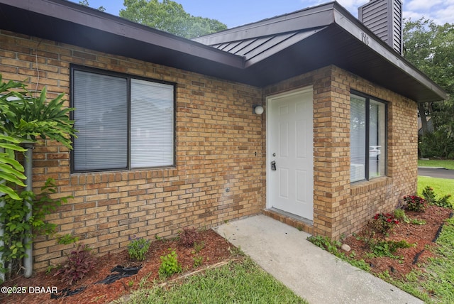 1518 Franklin Cir, Holly Hill, FL 32117 - property entrance with brick siding and a chimney