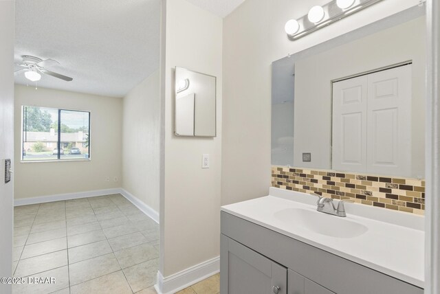 1518 Franklin Cir, Holly Hill, FL 32117 - bathroom featuring tile patterned flooring, vanity, baseboards, and a ceiling fan
