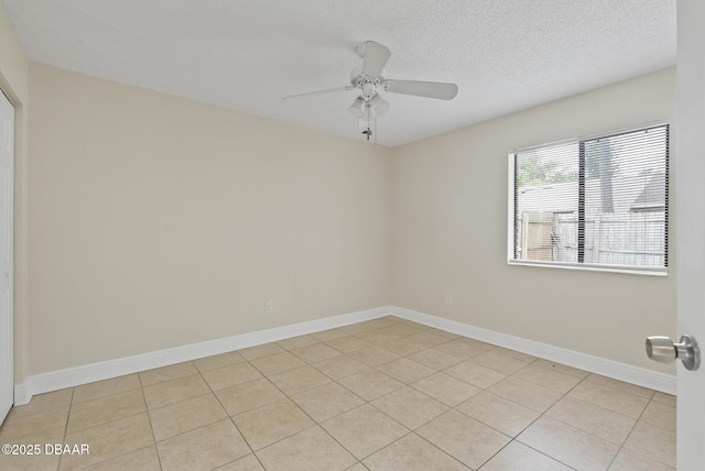 1518 Franklin Cir, Holly Hill, FL 32117 - unfurnished room with ceiling fan, light tile patterned floors, baseboards, and a textured ceiling