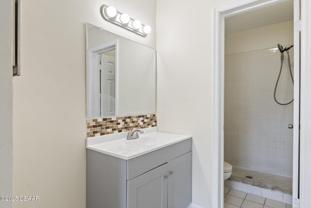 1518 Franklin Cir, Holly Hill, FL 32117 - full bath featuring vanity, toilet, tiled shower, decorative backsplash, and tile patterned floors