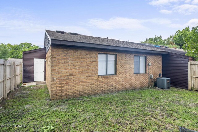 1518 Franklin Cir, Holly Hill, FL 32117 - view of side of home with brick siding, cooling unit, and roof with shingles