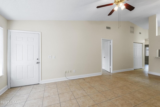 1518 Franklin Cir, Holly Hill, FL 32117 - empty room featuring light tile patterned floors, a ceiling fan, high vaulted ceiling, and baseboards