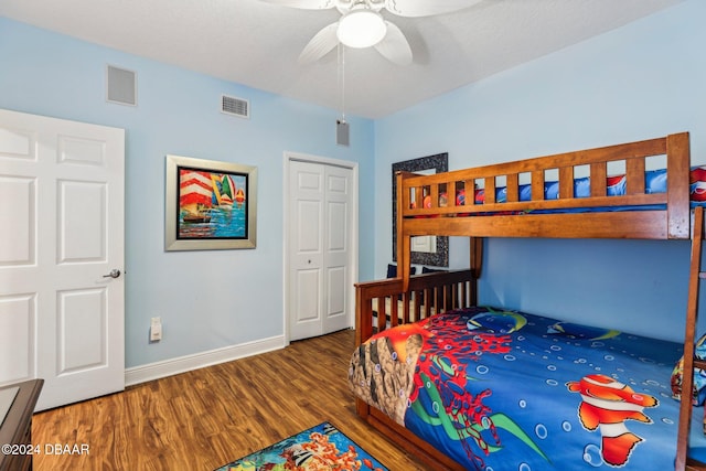 bedroom with ceiling fan, a closet, and dark hardwood / wood-style floors