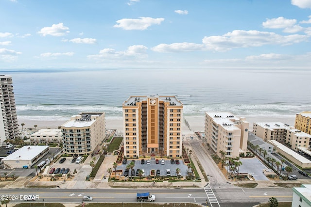 birds eye view of property featuring a beach view and a water view