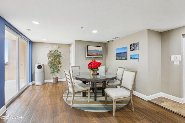 dining space with hardwood / wood-style flooring