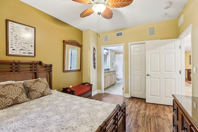 bedroom with ensuite bath, ceiling fan, and light wood-type flooring