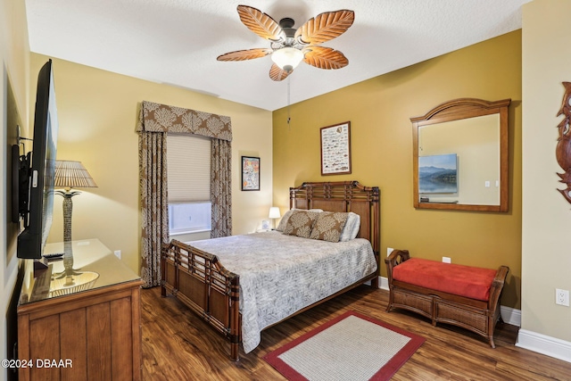 bedroom with ceiling fan and dark hardwood / wood-style flooring