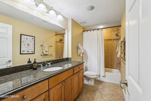 full bathroom with tile patterned floors, a textured ceiling, toilet, vanity, and shower / tub combo