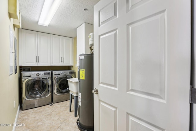 clothes washing area with electric water heater, cabinets, independent washer and dryer, and a textured ceiling