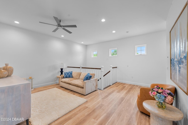 living room with light hardwood / wood-style floors and ceiling fan