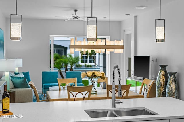 kitchen with ceiling fan, sink, and pendant lighting