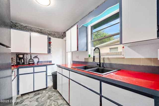 600 Holmes Ave, Daytona Beach, FL 32114 - kitchen with dark countertops and white cabinetry