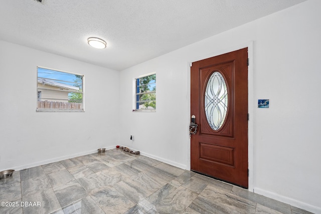 600 Holmes Ave, Daytona Beach, FL 32114 - foyer featuring baseboards and a textured ceiling
