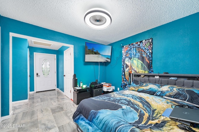 600 Holmes Ave, Daytona Beach, FL 32114 - bedroom featuring a textured ceiling and baseboards