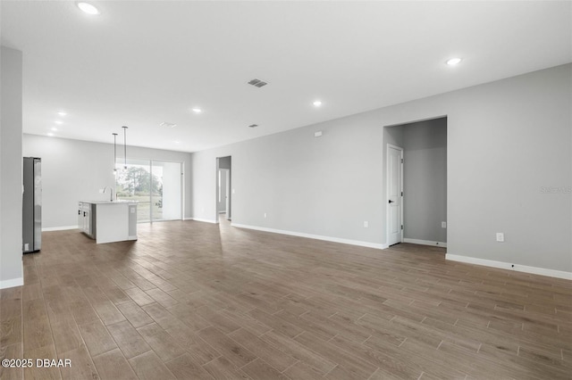 23 Weymouth Ln, Palm Coast, FL 32164 - unfurnished living room featuring wood finished floors and recessed lighting