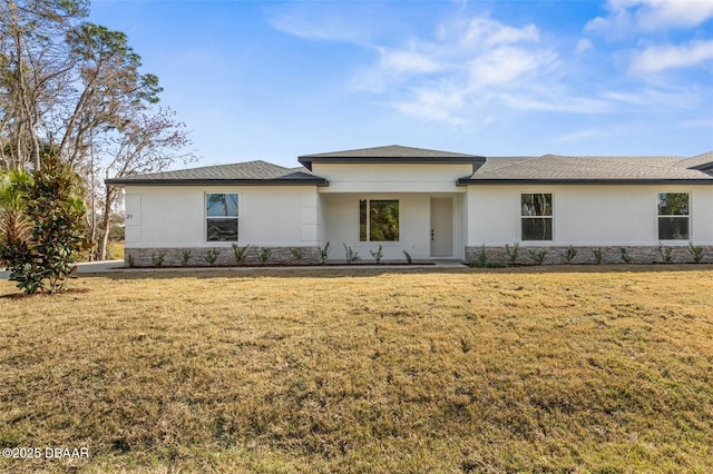 23 Weymouth Ln, Palm Coast, FL 32164 - prairie-style house with stone siding, stucco siding, and a front lawn