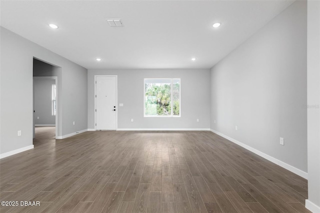23 Weymouth Ln, Palm Coast, FL 32164 - unfurnished living room with dark wood-type flooring and recessed lighting
