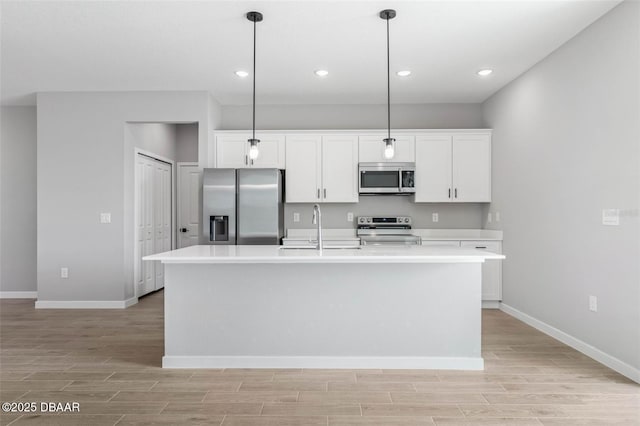 23 Weymouth Ln, Palm Coast, FL 32164 - kitchen featuring stainless steel appliances, light wood-style flooring, white cabinets, light countertops, and recessed lighting