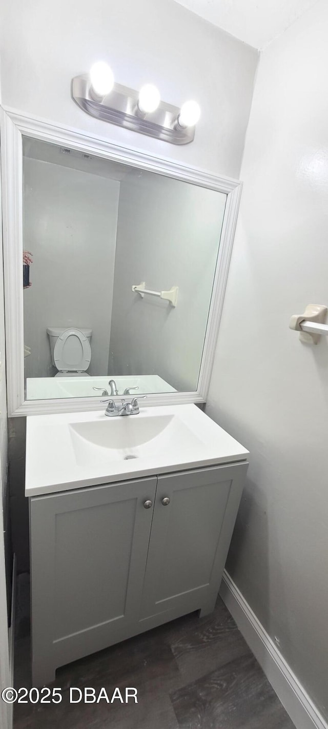 bathroom featuring baseboards and vanity