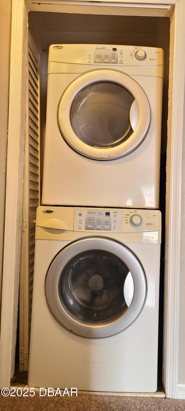 laundry room featuring stacked washer and clothes dryer and laundry area