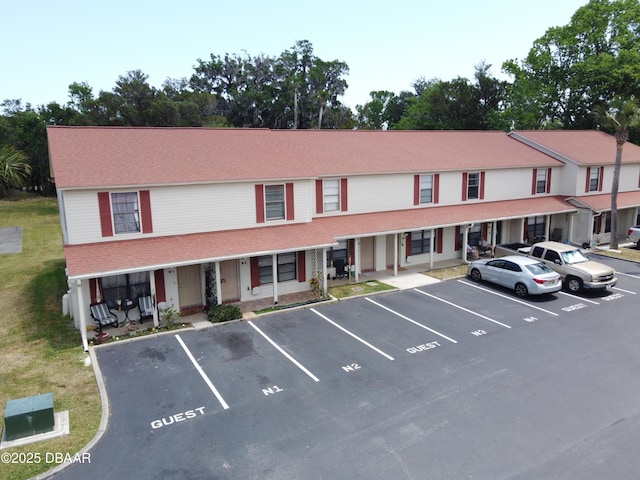 view of building exterior with uncovered parking