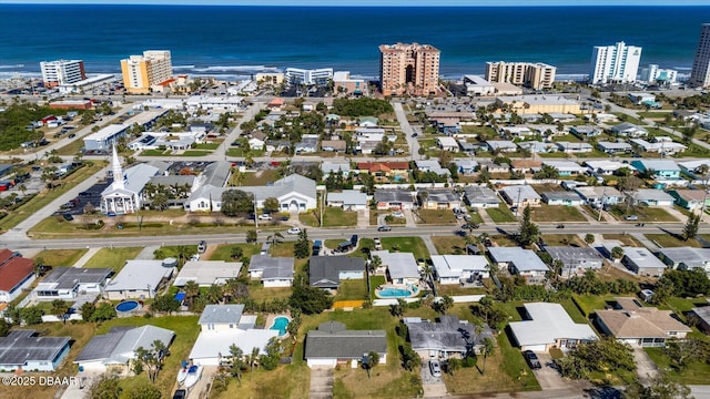 birds eye view of property with a water view and a view of city